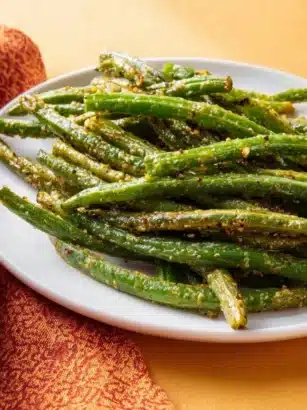 Air Fryer Parmesan Green Beans garnished with Parmesan cheese and spices