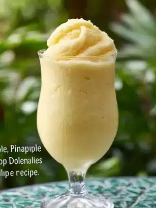 Pin by Kirsty Tegg on Disney recipes: A Refreshing Dole Whip Smoothie 7 Delicious Dole whip recipe served in a colorful cup with a straw