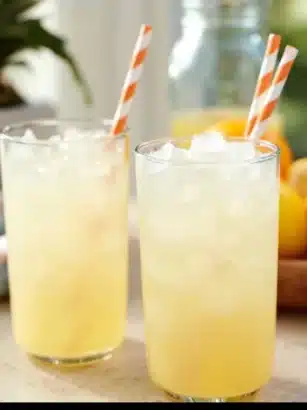 A refreshing glass of homemade pineapple lemonade with fresh pineapple slices