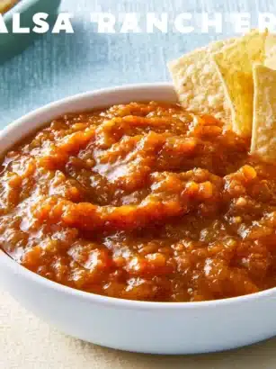 Homemade Ranchera Sauce served in a bowl with fresh ingredients.