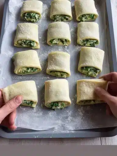 Golden brown spinach feta pastries on a white plate