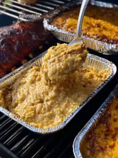Smoked BBQ sauce paired with cheesy potato bake and BBQ sides for summer grilling.
